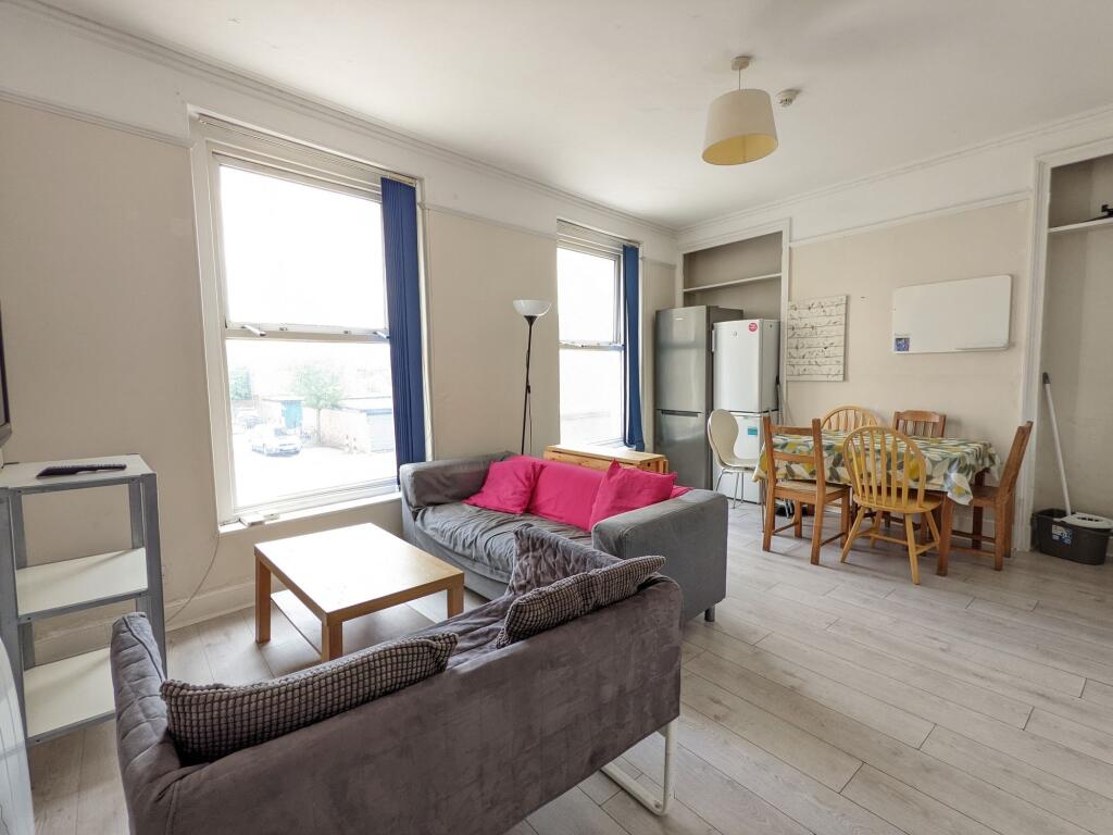 Bright, open living and dining area with large ...