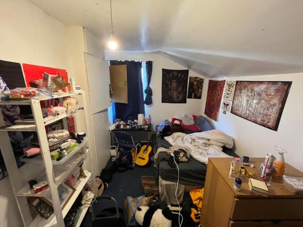 A cozy double bedroom with a creative atmospher...