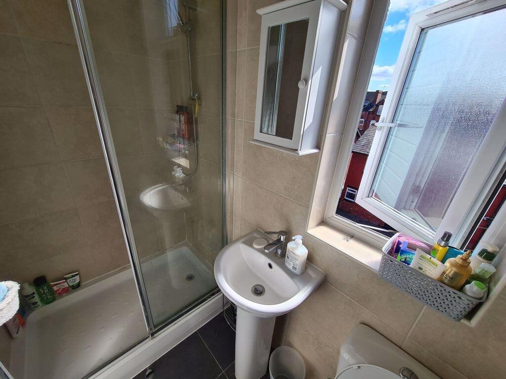 A clean and modern bathroom featuring a glass-e...
