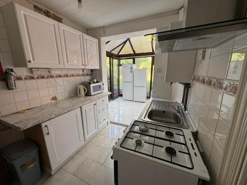 A bright and modern kitchenette with ample spac...