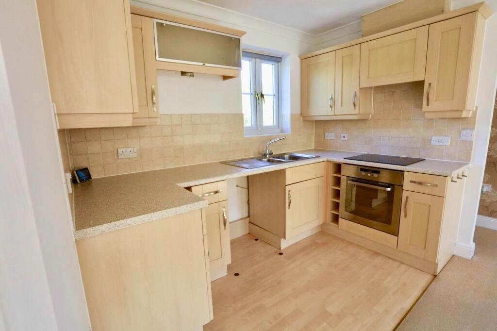 Kitchen with range of wall and base units.