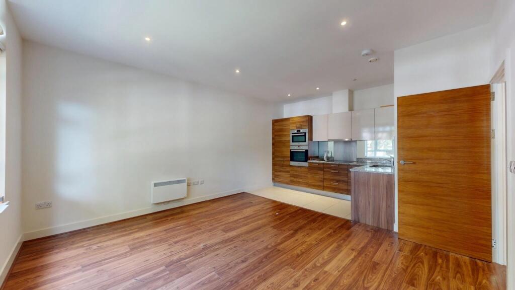 Bright and modern living room featuring sleek b...