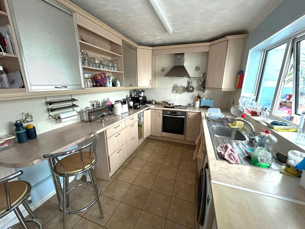Bright, well-equipped galley kitchen with moder...