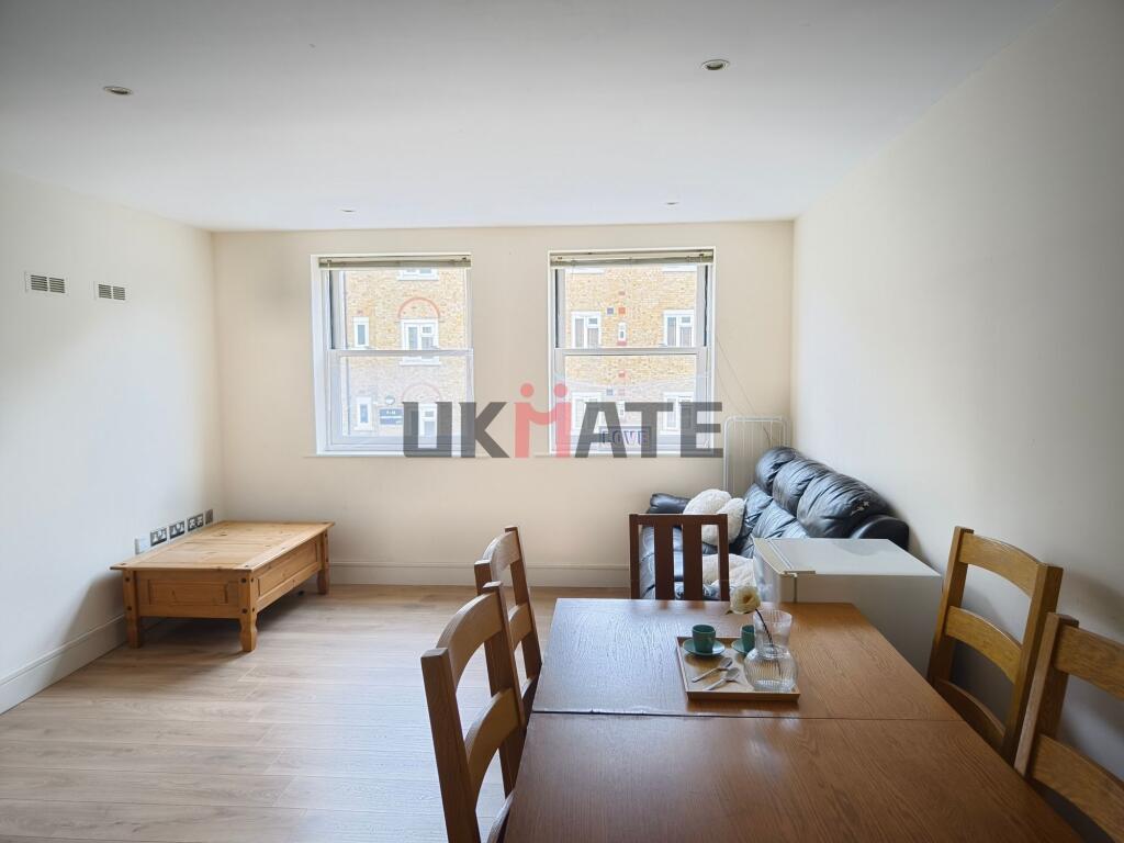 Bright and spacious living room with large wind...