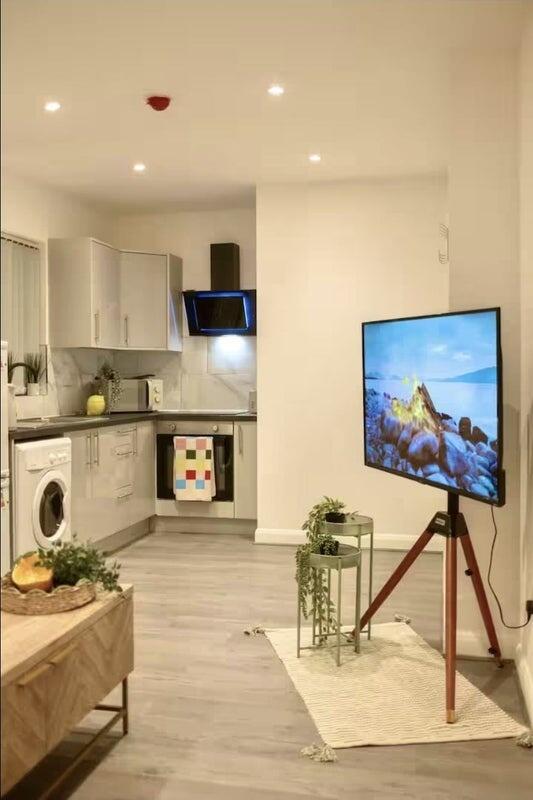 A modern kitchen with sleek white cabinets, int...
