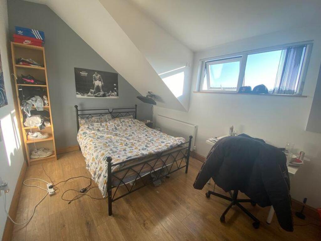 A bright and cozy double bedroom featuring ampl...