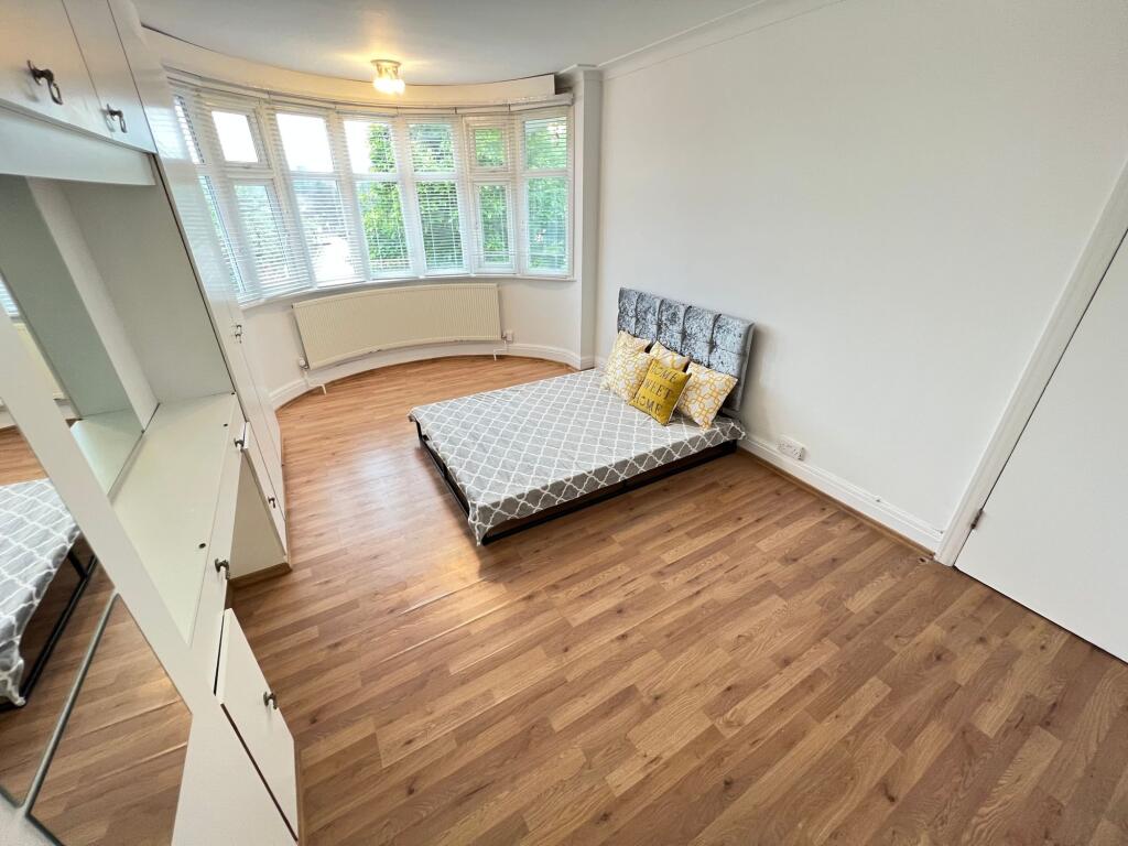 A bright and airy double bedroom featuring a la...
