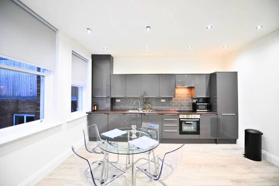 Modern kitchen with sleek grey cabinets and bui...