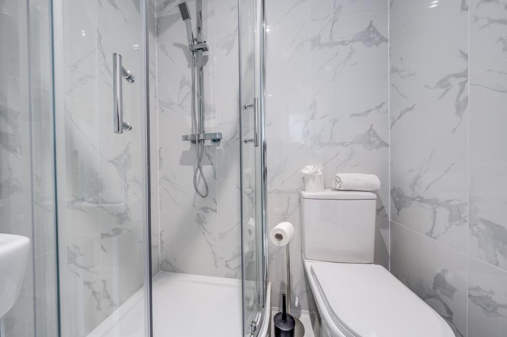 Contemporary bathroom featuring sleek marble wa...