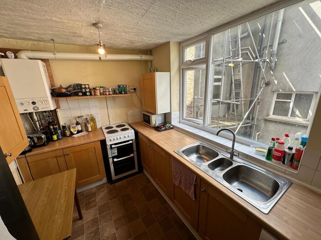 A spacious and well-lit kitchenette with modern...