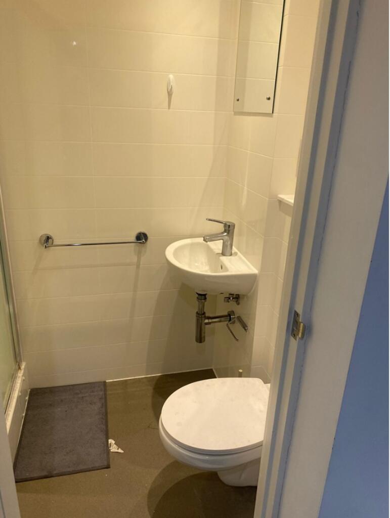 A tidy bathroom featuring essential amenities, ...