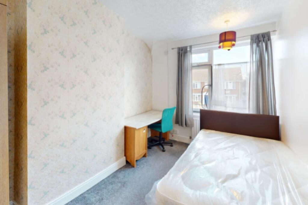 Bright and inviting double bedroom featuring a ...
