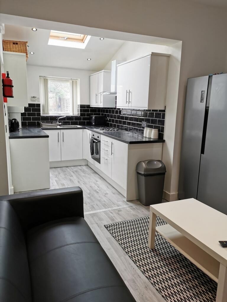 Modern kitchen featuring sleek black and white ...