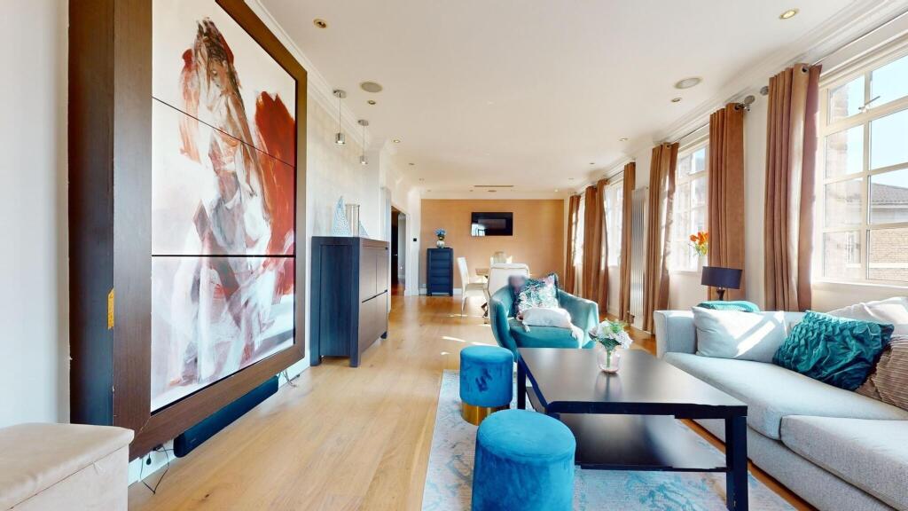 Bright and spacious living room featuring large...
