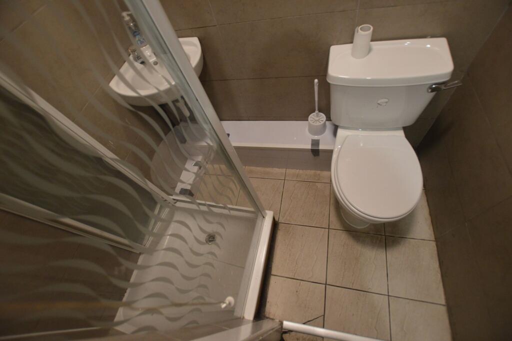 Compact and functional bathroom featuring a cor...