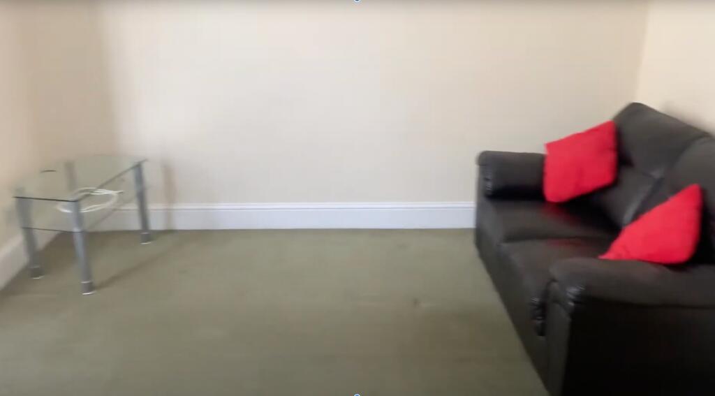 A cozy living room featuring a dark sofa with t...