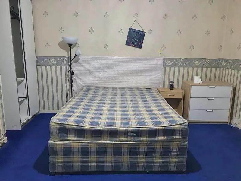 A cozy double bedroom featuring a comfortable d...