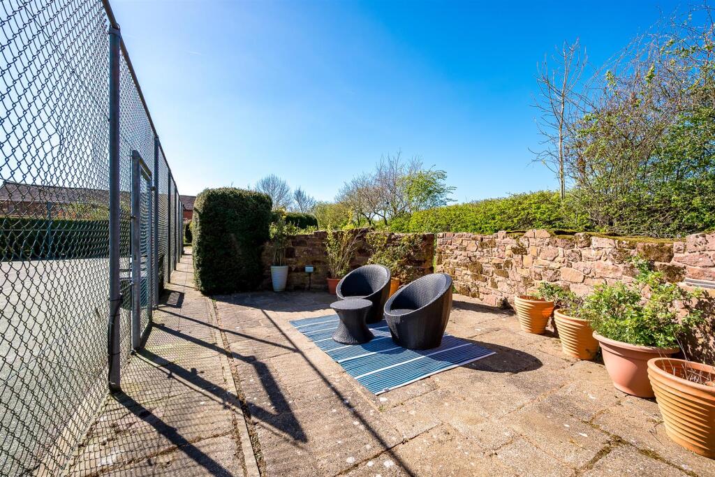 Seating area overlooking tennis court