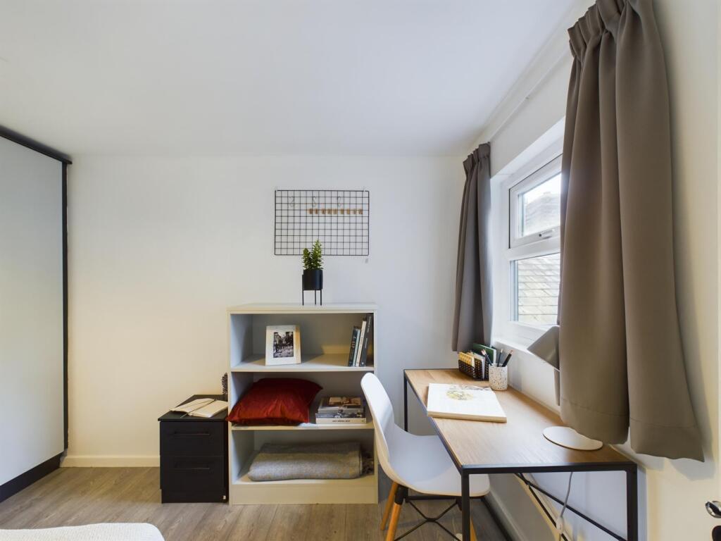 A bright and tidy double bedroom featuring a co...