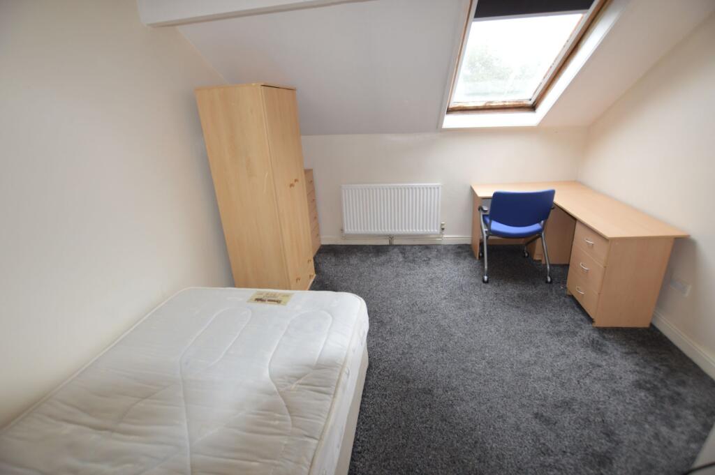 A neat and bright single bedroom featuring a la...