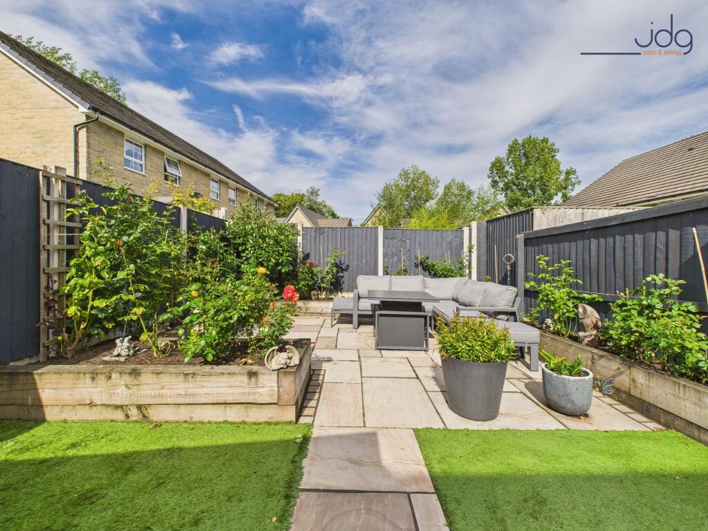 Beautifully Landscaped Garden with mixture of flags and artificial grass