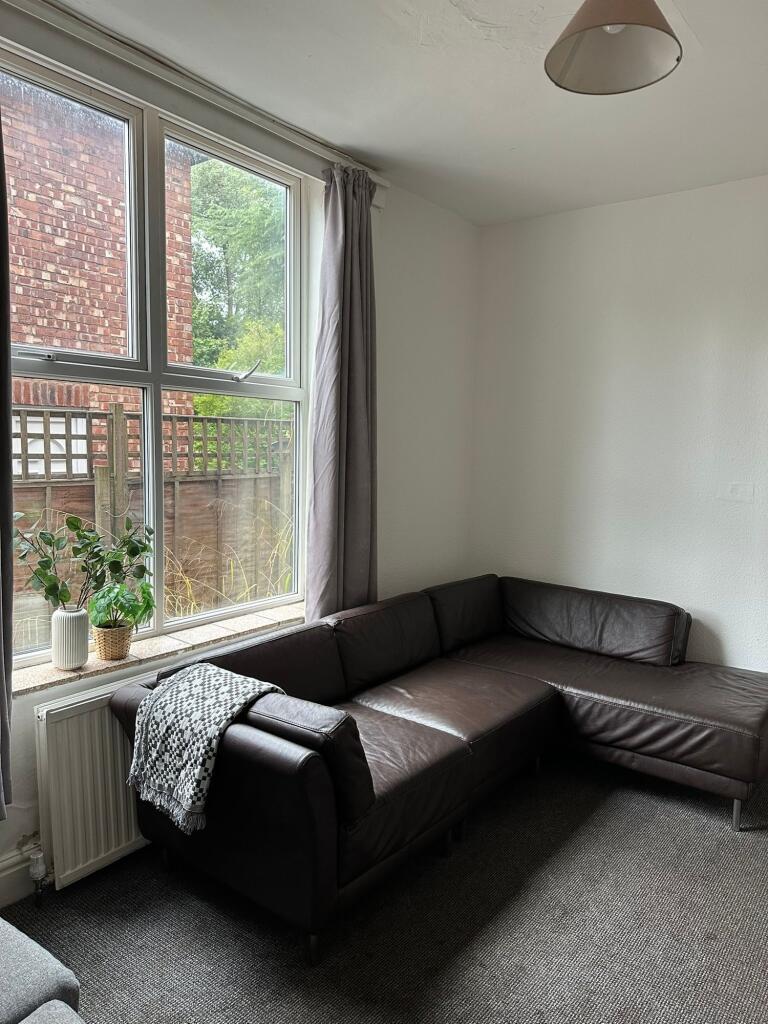 A bright and welcoming living room featuring a ...