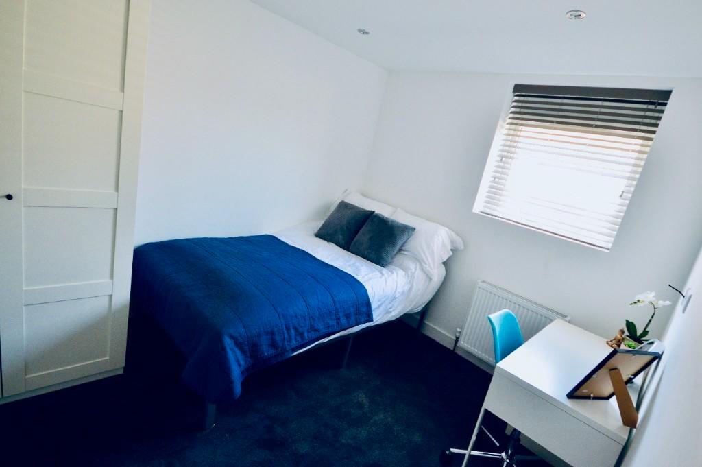 Cozy double bedroom featuring a comfortable bed...