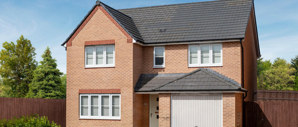 Modern brick house with white-framed windows, grey roof tiles, and a garage, set against a blue sky