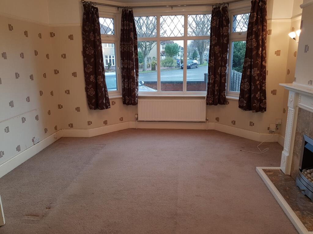 A spacious and bright living room with large wi...