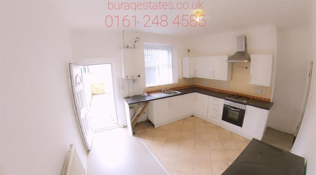 Bright and modern kitchen featuring ample natur...