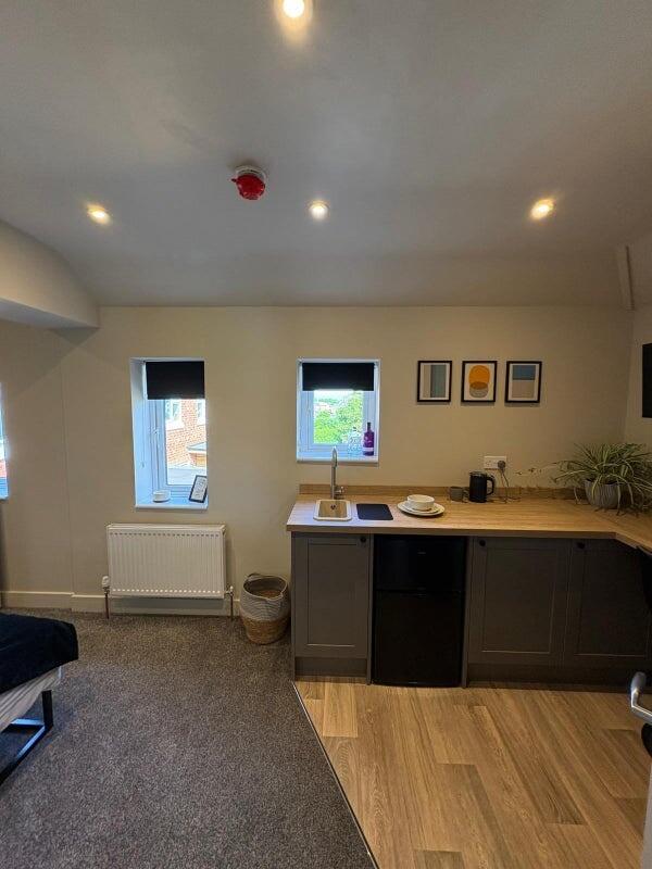 A modern, compact studio space featuring a neat...