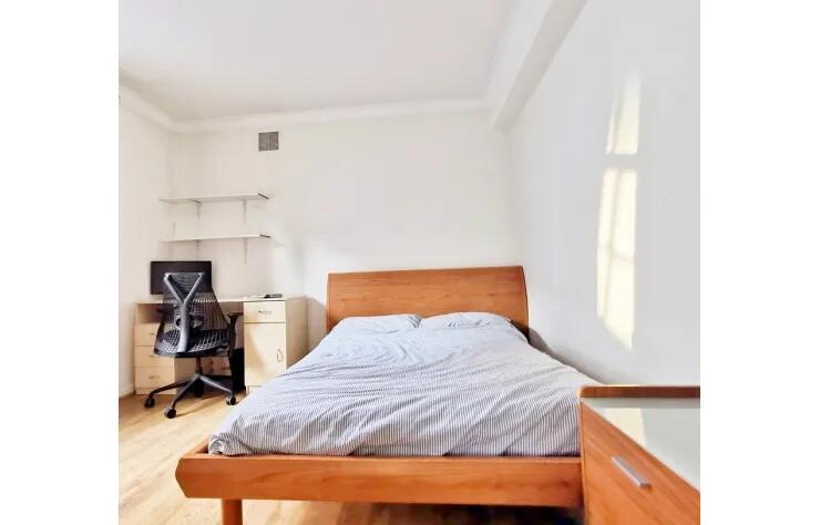 Bright and tidy double bedroom featuring a comf...