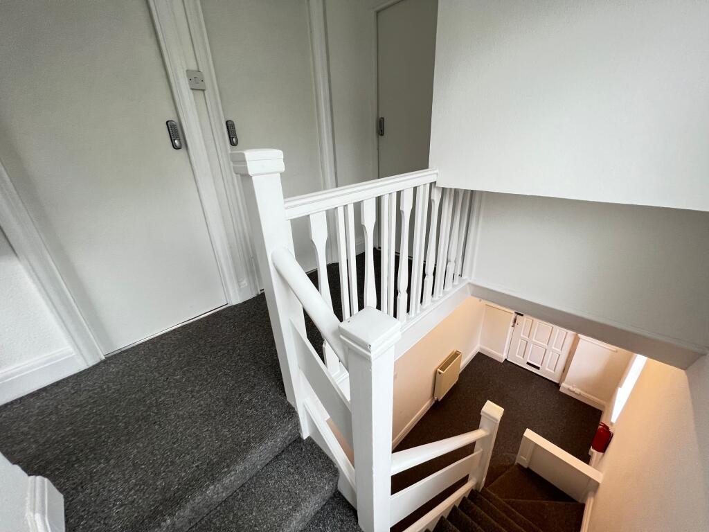A clean and well-maintained staircase area with...