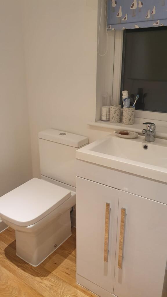 A bright and tidy bathroom featuring modern fix...