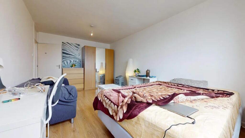 A spacious and well-organized master bedroom fe...