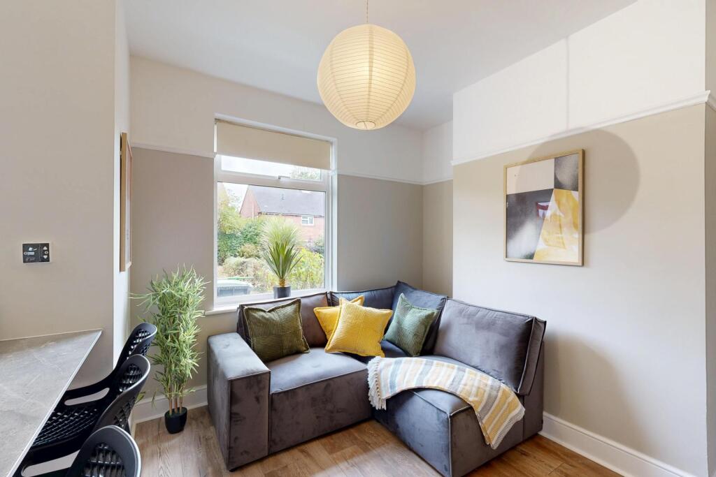 A bright and welcoming living room featuring a ...