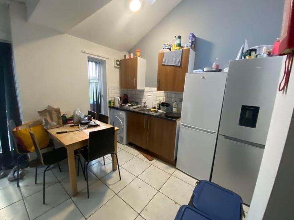 A functional kitchenette with ample storage and...