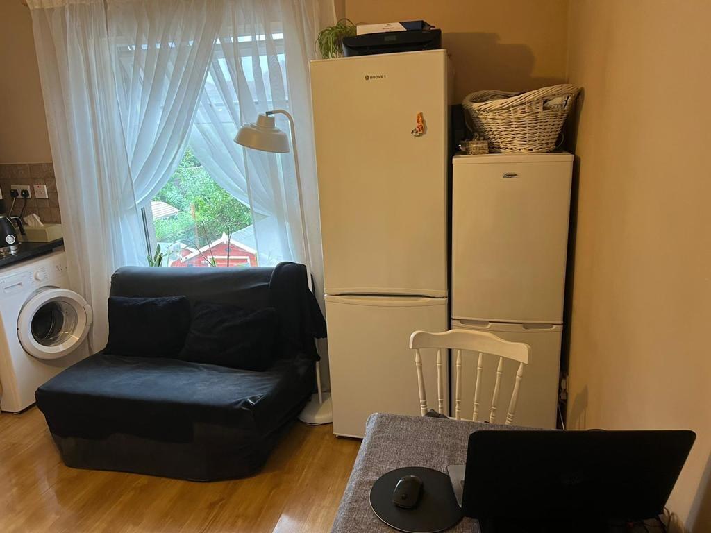 A cozy kitchen area featuring a washing machine...