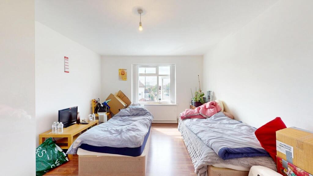A bright and tidy double bedroom featuring two ...