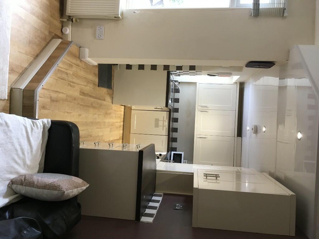 A modern kitchen featuring clean white cabinets...