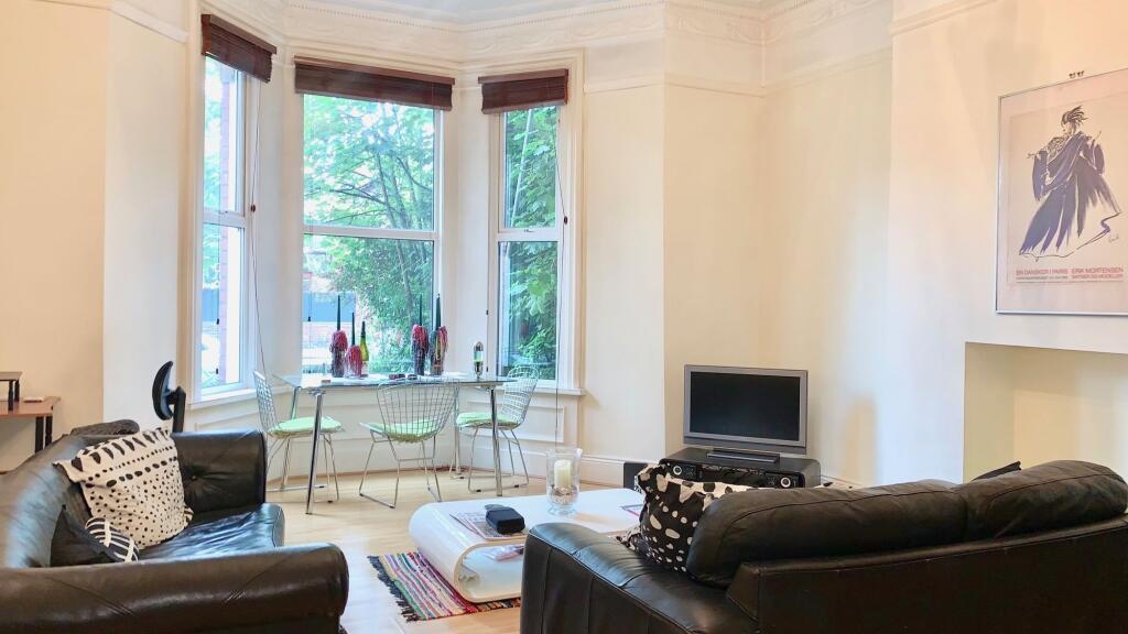 A bright and welcoming living room featuring la...
