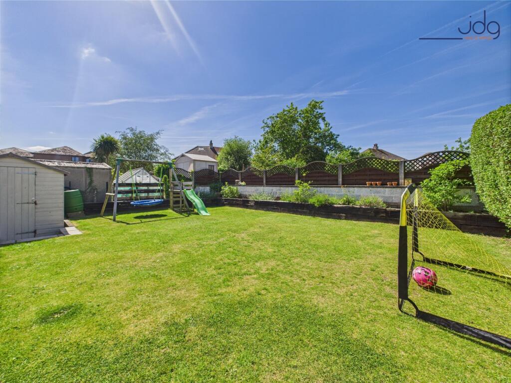 Raised beds, and a large lawn bordered by mature planting