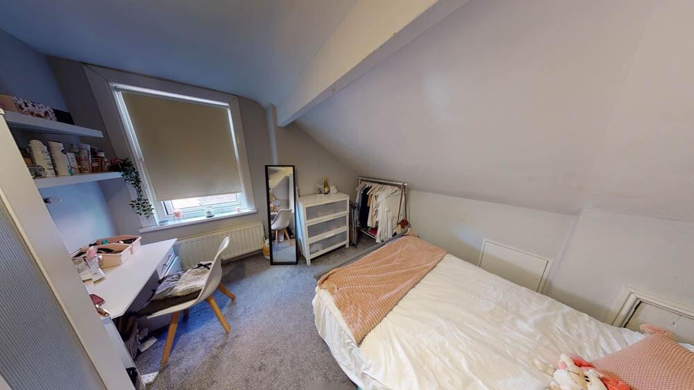 Bright and cozy bedroom featuring a single bed,...