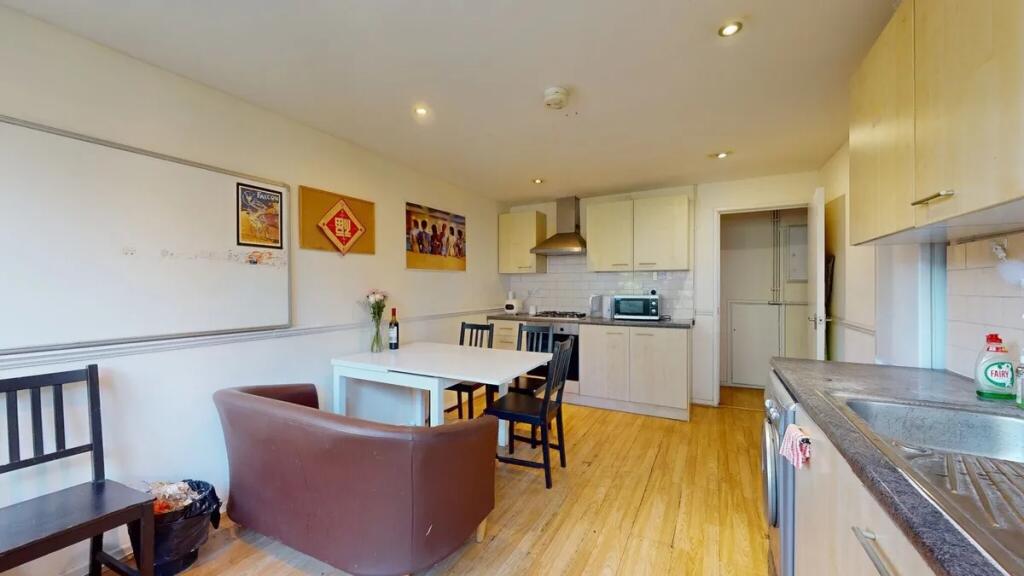 Bright and tidy kitchen featuring modern applia...