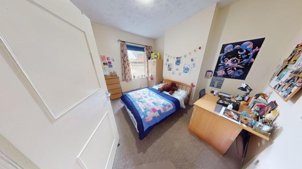 A bright and clean student bedroom featuring a ...