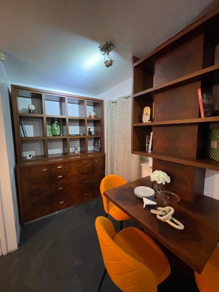 A stylish communal workspace featuring modern d...