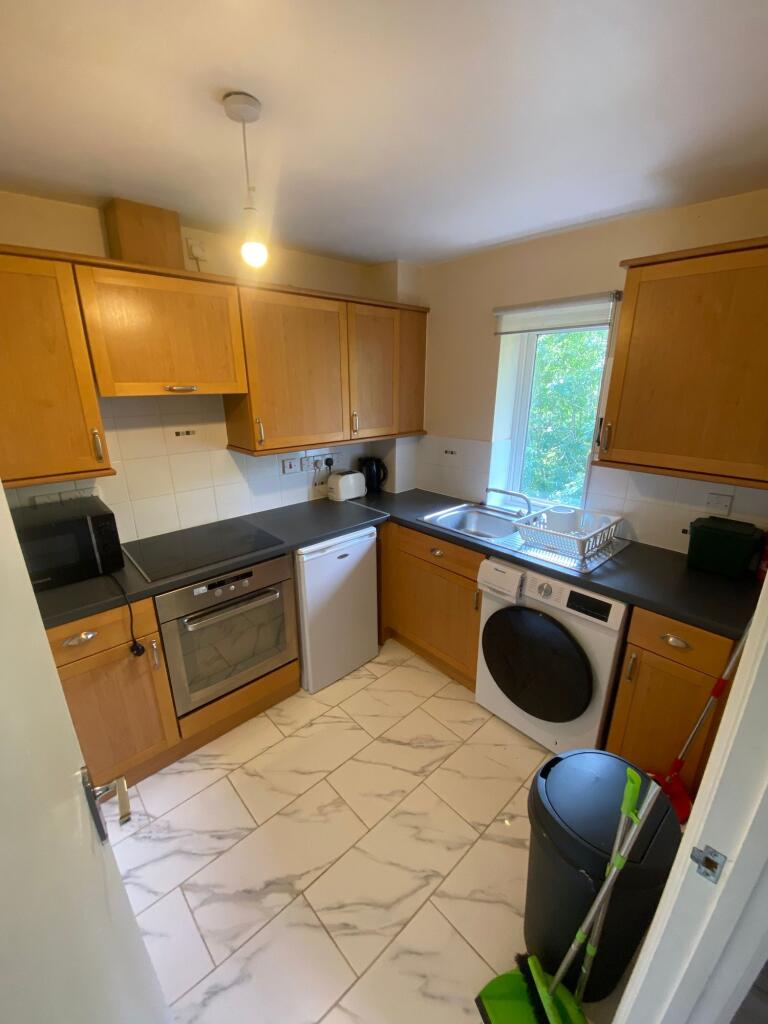 Bright and functional kitchen with ample cabine...