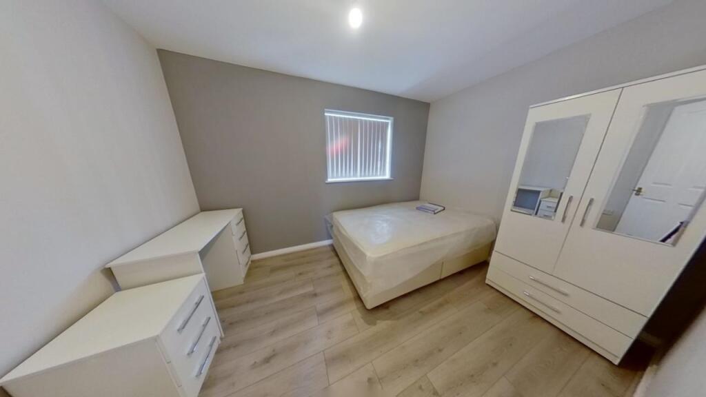 A clean and modern single toilet room with neut...