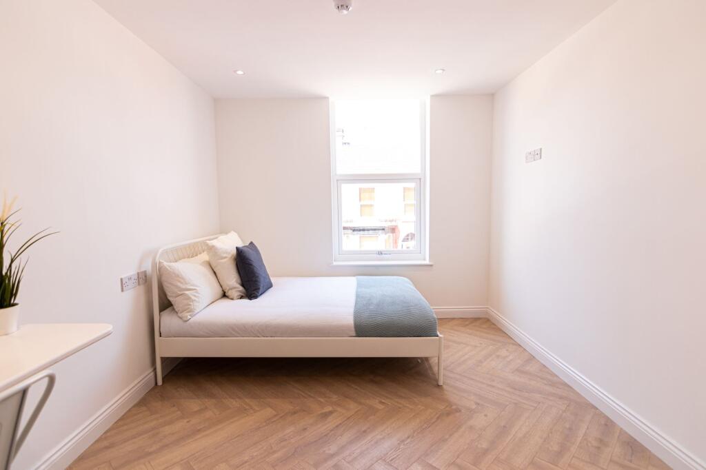 Bright and inviting bedroom with a large window...