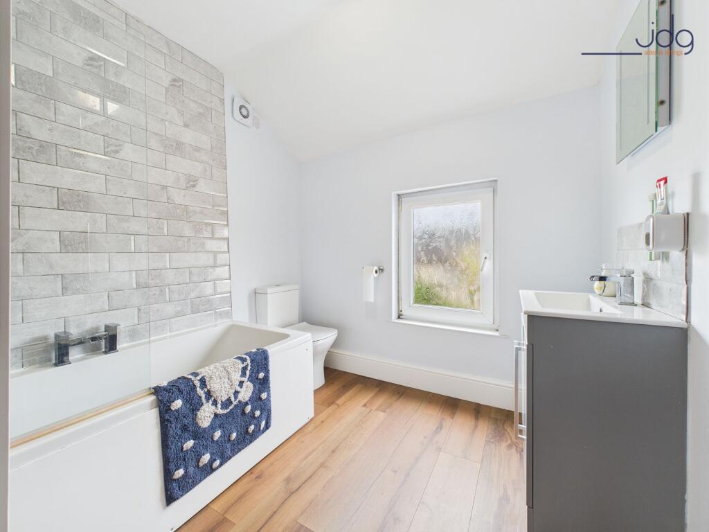 Modern three-piece suite and wood-effect vinyl flooring